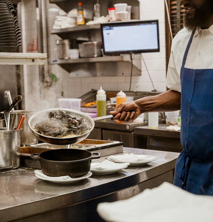 a man standing in a kitchen preparing food